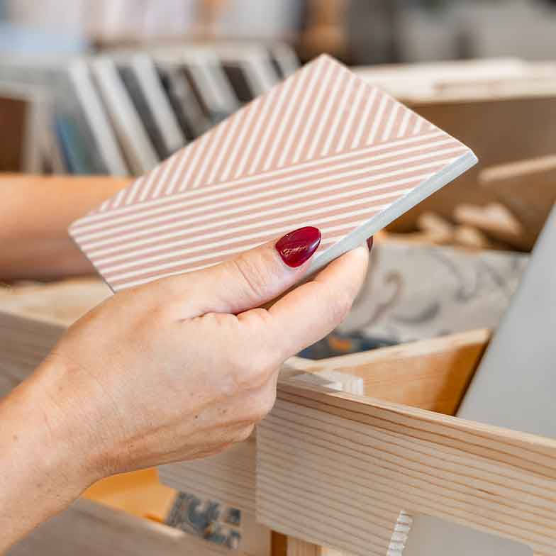 Woman examining hand made tiles